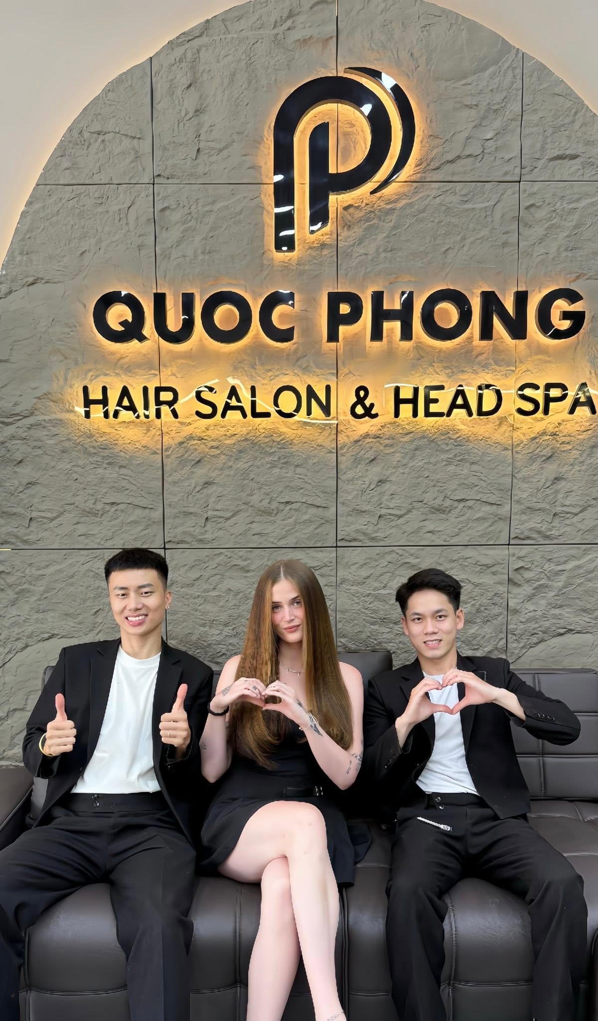 Quoc Phong stylists with a happy customer