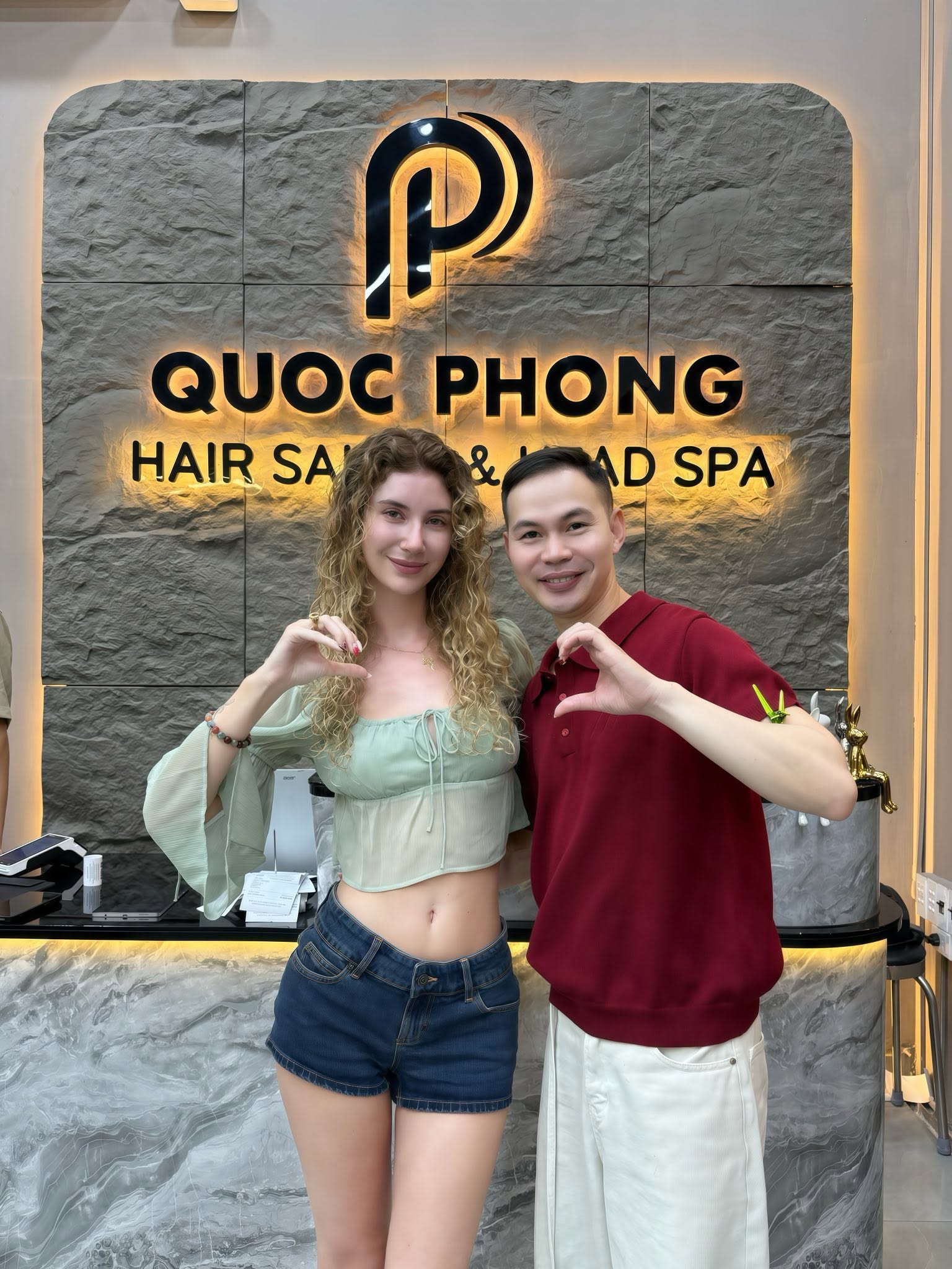 Quoc Phong stylist with a happy customer after her curly perm