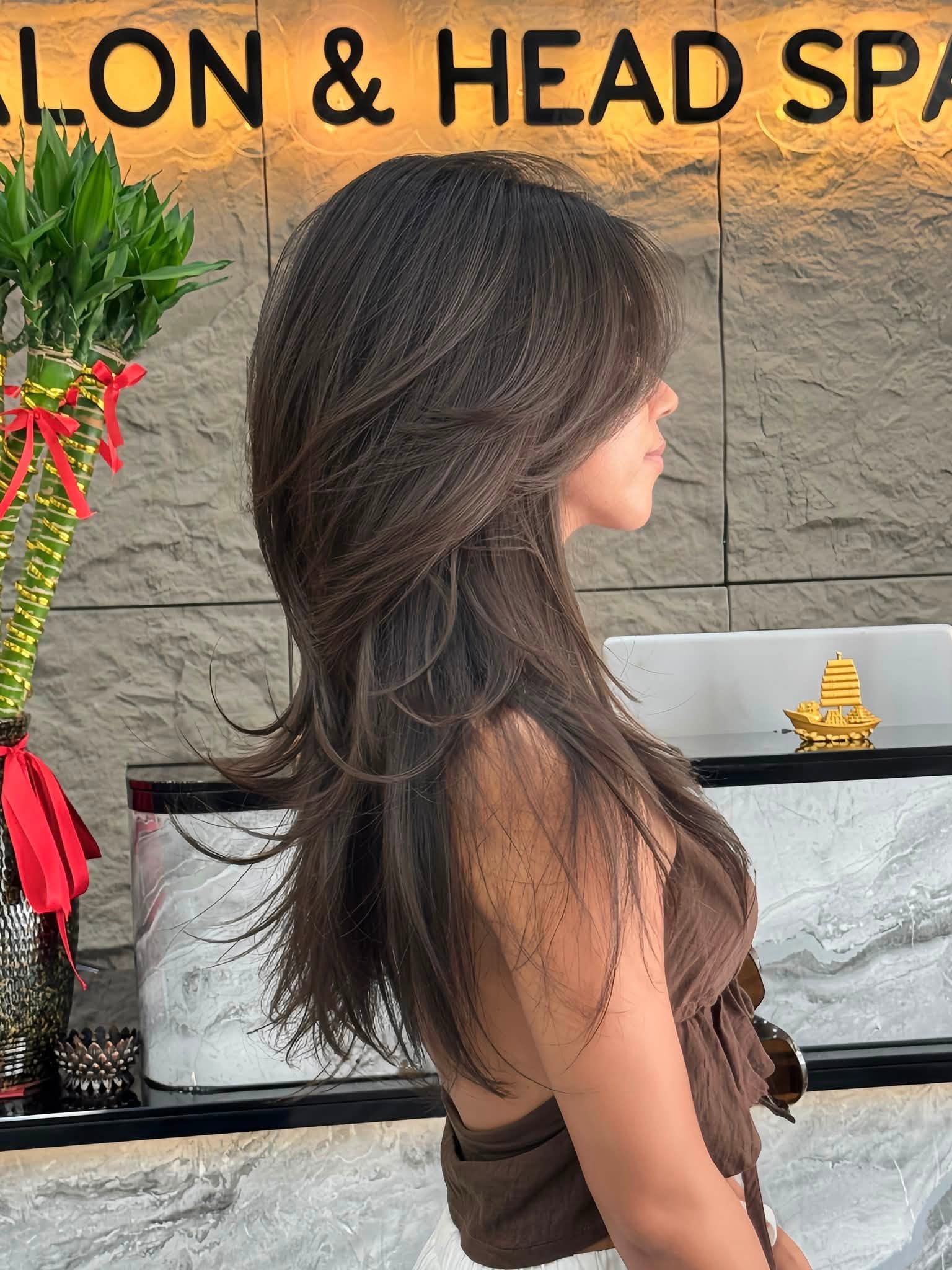 Long layered brunette haircut by Quoc Phong